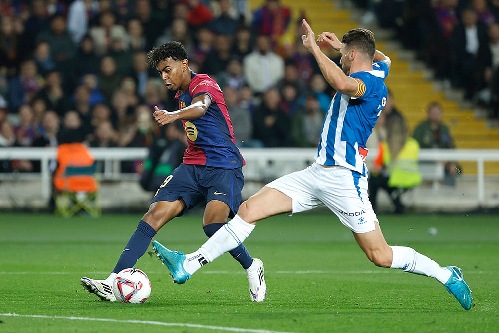 | Photo: AP/Joan Monfort : La Liga 2024-25: Barcelona's Lamine Yamal, left, challenges for the ball with Espanyol's Sergi Gomez 
