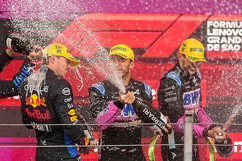 Brazilian Grand Prix 2024: Max Verstappen, left, Alpine driver Pierre Gasly, center, and Alpine driver Esteban Ocon, celebrate on the podium