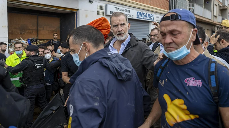 Spanish King Felipe VI, centre, walks amidst angry Spanish flood survivors.