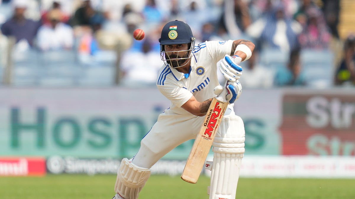 AP Photo/Rafiq Maqbool : India's Virat Kohli plays a shot during day three of the second cricket test match between India and New Zealand at the Maharashtra Cricket Association Stadium, in Pune.