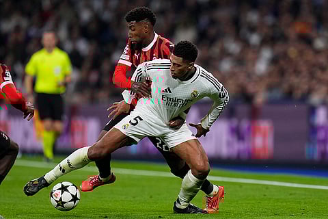 Champions League 2024-25: Real Madrid's Jude Bellingham, front, and AC Milan's Emerson Royal battle for the ball