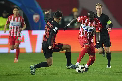 UEFA Champions League: Barcelona's Gerard Martín. left, and Red Star's Cherif Ndiaye fight for the ball