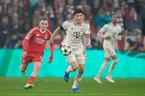 UEFA Champions League: Bayern's Kim Min-jae runs with the ball, followed by Benfica's Kerem Akturkoglu