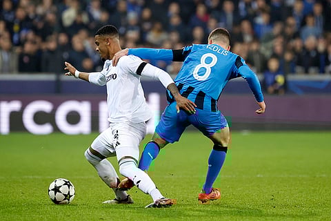 UEFA Champions League: Brugge's Christos Tzolis, right, holds Aston Villa's Ezri Konsa