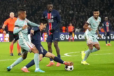 UEFA Champions League: Atletico Madrid's Reinildo Mandava, left, and PSG's Lee Kang-in fight for the ball