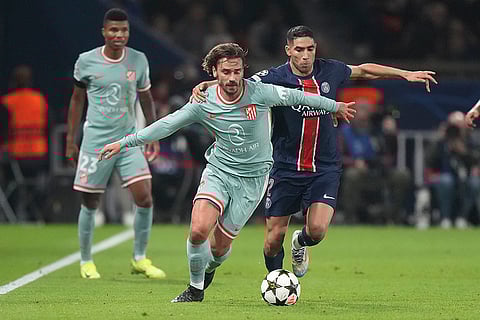 UEFA Champions League: Atletico Madrid's Antoine Griezmann, left, and PSG's Achraf Hakimi vie for the ball
