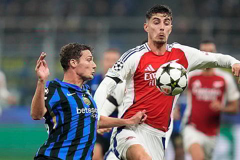 UEFA Champions League: Arsenal's Kai Havertz, right, challenges for the ball with Inter Milan's Benjamin Pavard