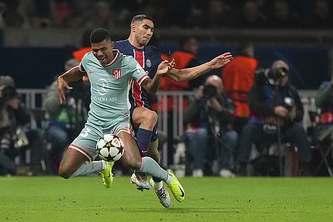UEFA Champions League: Atletico Madrid's Reinildo Mandava, front, and PSG's Achraf Hakimi fight for the ball
