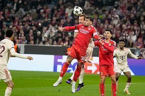 UEFA Champions League: Bayern's Harry Kane jumps for the ball with Benfica's Nicolas Otamendi
