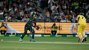 AP Photo/Asanka Brendon Ratnayake : Pakistan's Mohammad Rizwan, left, runs out Australia's Sean Abbott during their one-day international cricket match in Melbourne.