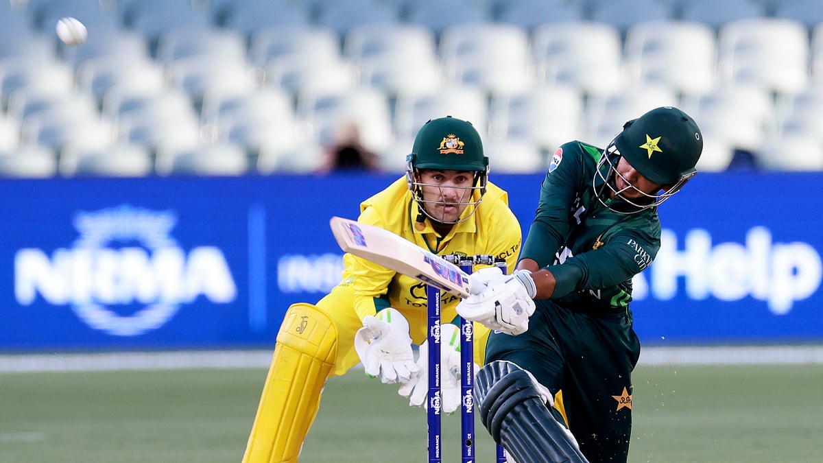 AP Photo/James Elsby : Pakistan's Saim Ayub, right, hits a six in front of Australia's Josh Inglis during their one-day international cricket match in Adelaide.