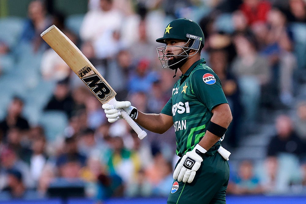 | Photo: AP/James Elsby : Australia vs Pakistan 2nd ODI: Pakistan's Abdullah Shafique raises his bat after making 50 runs 