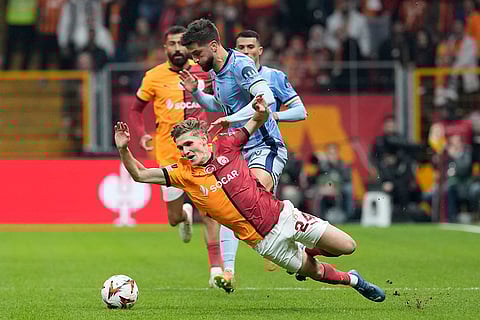 Europa League: Galatasaray's Elias Jelert challenges for the ball with Tottenham's Rodrigo Bentancur