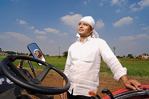 Vinayak Shinde, a second-generation farmer, near his onion farm