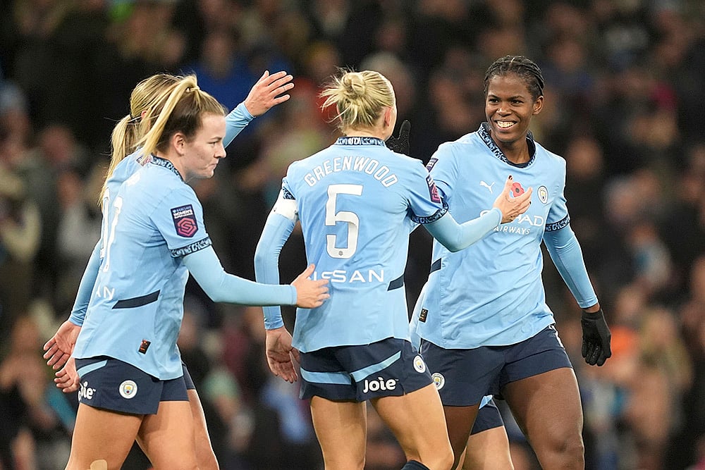 | Photo: Martin Rickett/PA via AP : Women's Super League: Manchester City's Khadija Shaw, right, celebrates scoring their side's fourth goal 