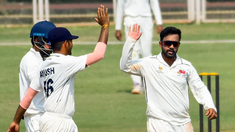 Mumbai bowler Shams Mulani (Right) being greeted after he took a 5-wicket haul during a Ranji Trophy match against Odisha, at Sharad Pawar Indoor Cricket Academy, in Mumbai. - PTI/PARSEKAR
