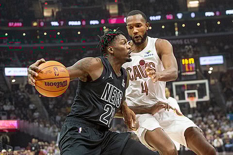 NBA: Nets' Dorian Finney-Smith (28) drives against Cavaliers' Evan Mobley (4)