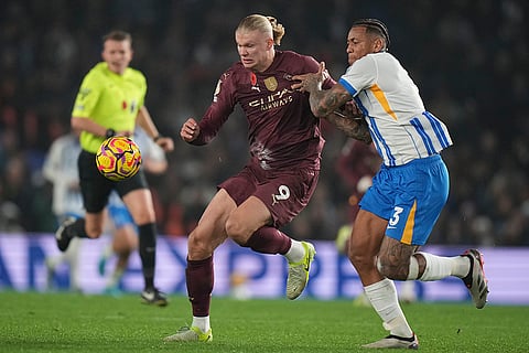 EPL 2024-25: Manchester City's Erling Haaland, left, and Brighton's Igor Julio fight for the ball