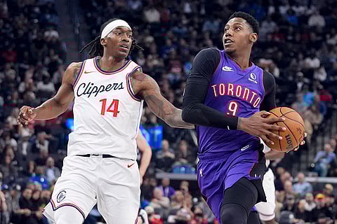 NBA: Raptors guard RJ Barrett (9) drives to the basket past Clippers guard Terance Mann (14)