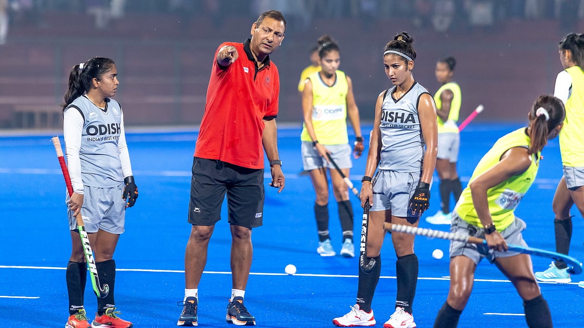 Hockey India : India women's hockey team coach Harendra Singh (centre) in conversation with forward Navneet Kaur (right) at training, ahead of their Asian Champions Trophy opener against Malaysia. 
