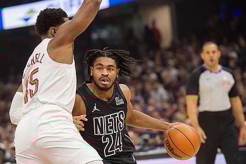 NBA: Nets' Cam Thomas (24) drives against Cleveland Cavaliers' Donovan Mitchell
