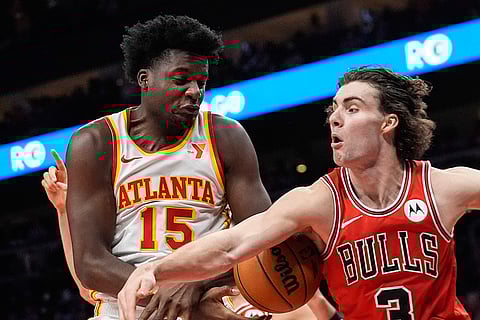 NBA: Bulls guard Josh Giddey (3) and Hawks center Clint Capela (15) battle for the ball