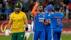 | Photo: AP/Themba Hadebe : IND vs SA 2nd T20: Varun Chakravarthy, center, celebrates after the dismissal of South Africa's captain Aiden Markram.