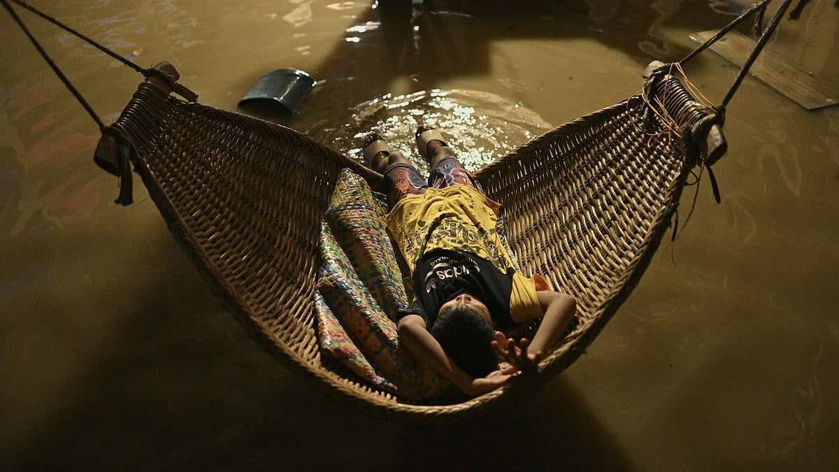 AP : A boy tries to sleep in his flooded house after Typhoon Yinxing, locally called Marce, blew past Buguey town, Cagayan province, northern Philippines on Friday Nov. 8, 2024.