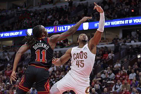 NBA Cavaliers vs Bulls: Cavaliers guard Donovan Mitchell drives to the basket for a layup against Bulls guard Ayo Dosunmu