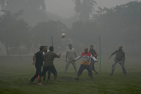 People play soccer in Lahore