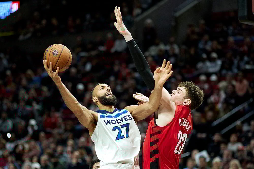| Photo: AP/Craig Mitchelldyer : NBA Cup: Timberwolves center Rudy Gobert, left, shoots over Trail Blazers center Donovan Clingan