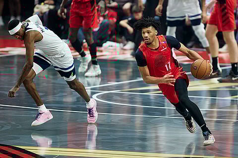 NBA Cup: Trail Blazers guard Shaedon Sharpe, right, dribbles past Timberwolves forward Jaden McDaniels