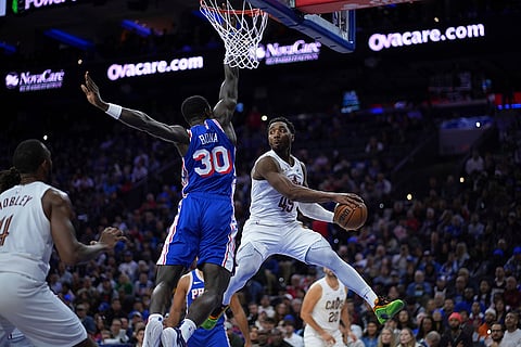 NBA: Cavaliers' Donovan Mitchell (45) passes against 76ers' Adem Bona (30)