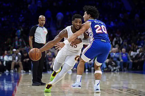 NBA: Cavaliers' Donovan Mitchell, left, tries to get past 76ers' Jared McCain