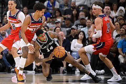 NBA: Spurs' Blake Wesley (14) tangles with Wizards' Jordan Poole (13) and Corey Kispert