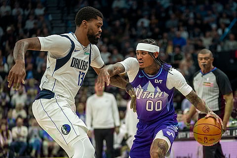 NBA Mavericks vs Jazz Basketball: Jazz guard Jordan Clarkson (00) is guarded by Mavericks forward Naji Marshall (13)