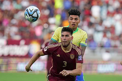 FIFA World Cup 2026 Qualifiers: Venezuela's Wilker Angel eyes the ball challenged by Brazil's Igor Jesus