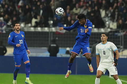 UEFA Nations League soccer: France's Kingsley Coman, centre, heads the ball