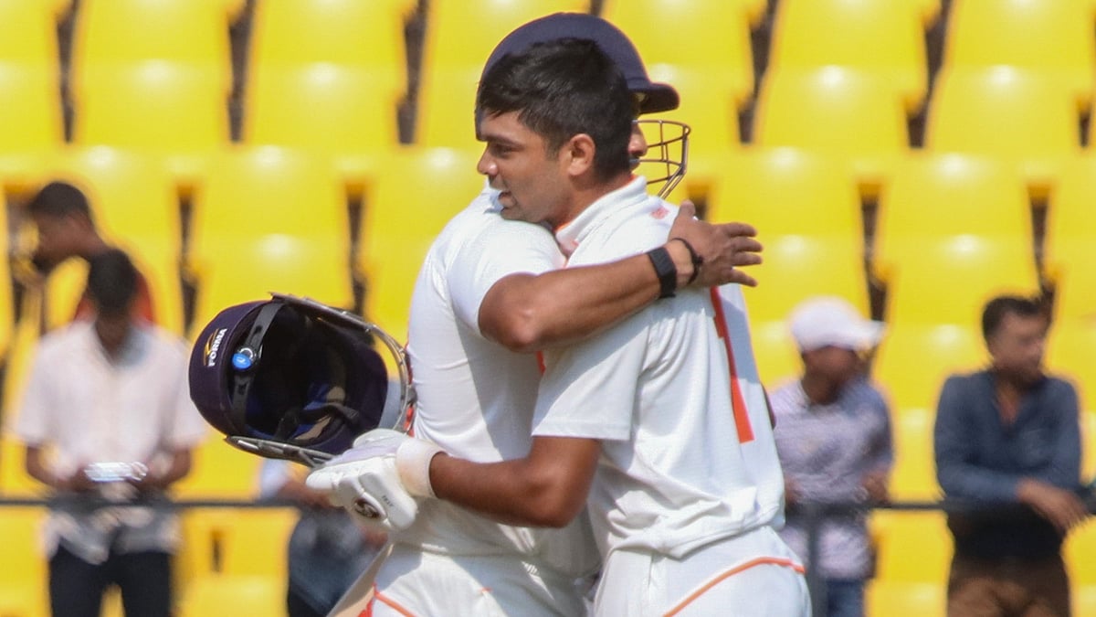 PTI : Vidarbha's batter Danish Malewar being greeted by Karun Nair (L) on his century on the third day of Ranji Trophy cricket match between Vidarbha and Gujarat, at VCA Stadium in Nagpur.