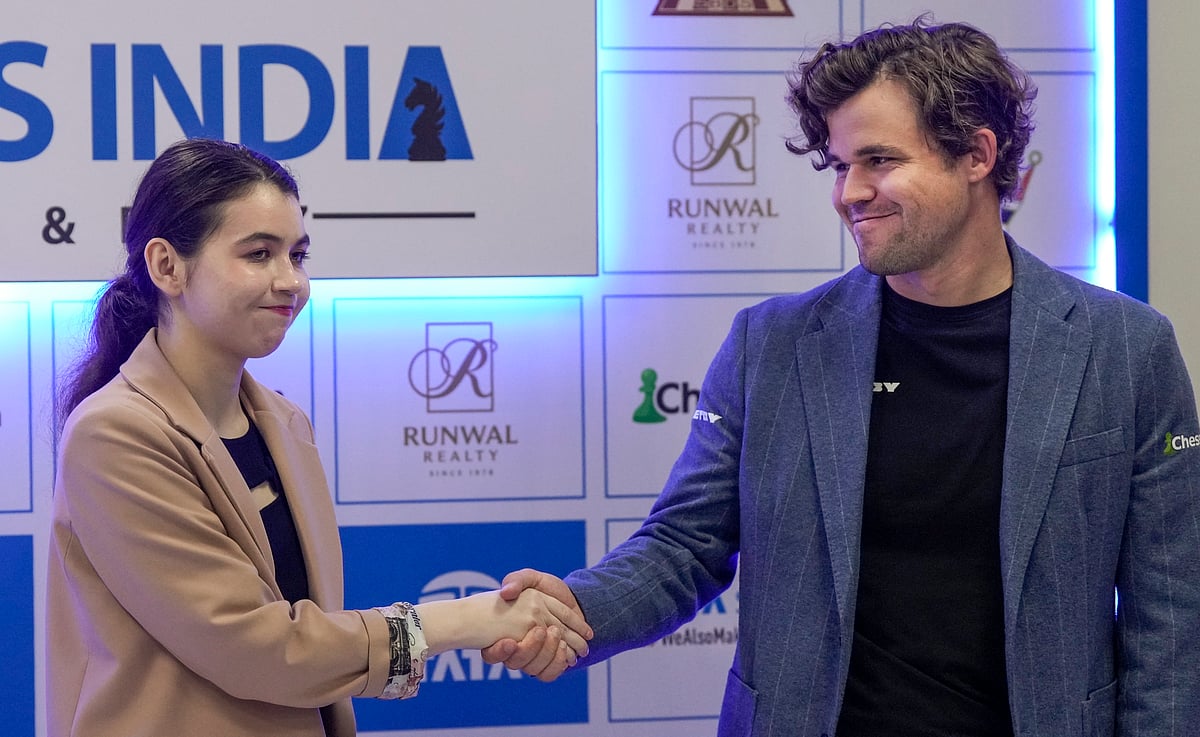 Russian GM Aleksandra Goryachkina and Magnus Carlsen of Norway greet each other after winning the Tata Steel Chess India Rapid title in the open and women categories, in Kolkata, Friday, Nov. 15, 2024. - AP/Swapan Mahapatra