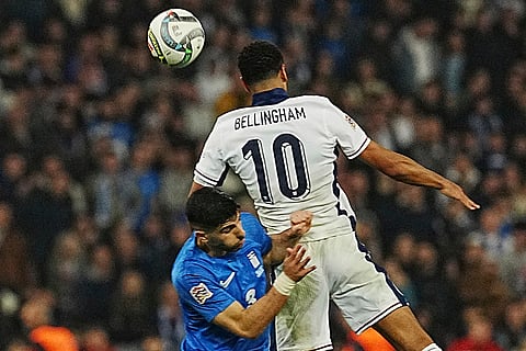 UEFA Nations League soccer: England's Jude Bellingham, top, and Konstantinos Koulierakis of Greece fight for the ball