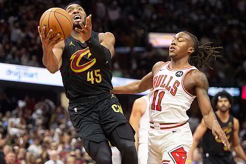 NBA: Cavaliers' Donovan Mitchell (45) drives to the basket in front of Bulls' Ayo Dosunmu