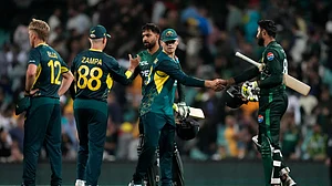 AP Photo/Rick Rycroft : Australia's Jake Fraser-McGurk shakes hands with Pakistan's Irfan Khan, right, after Australia won the T20 international cricket match against Pakistan in Sydney.