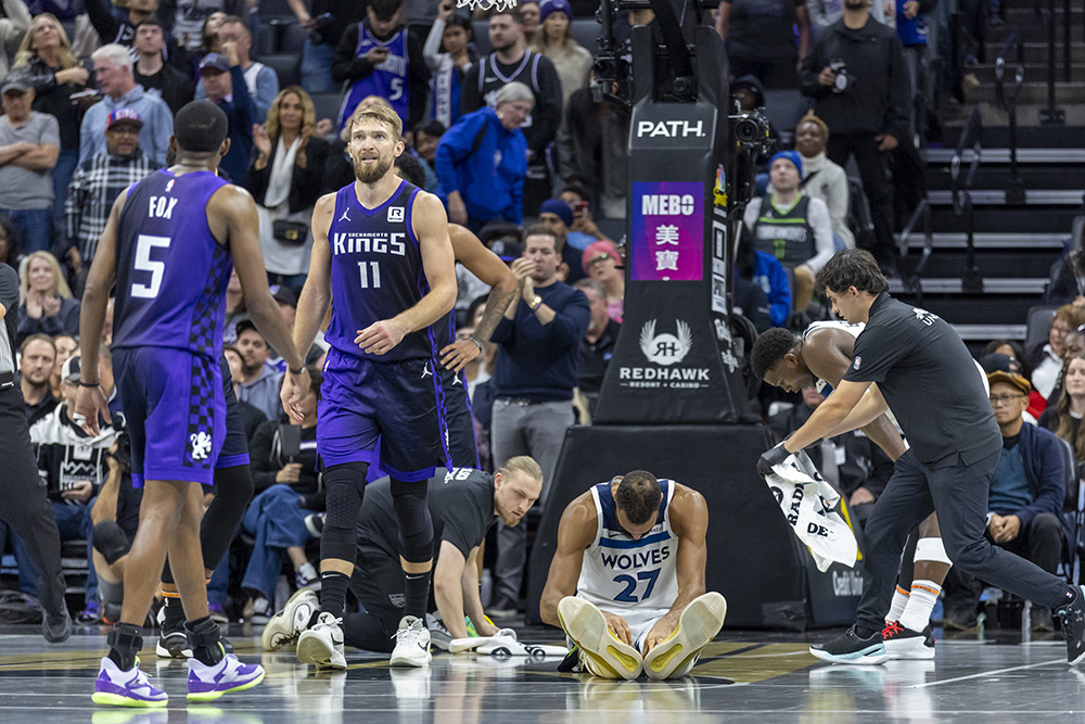 NBA: Timberwolves center Rudy Gobert (27) sits on the floor after forward Jaden McDaniels fouls out of the game