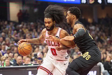 NBA: Bulls' Coby White (0) drives against Cavaliers' Donovan Mitchell