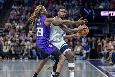 NBA: Timberwolves guard Anthony Edwards (5) dribbles the ball up court as Kings guard Keon Ellis