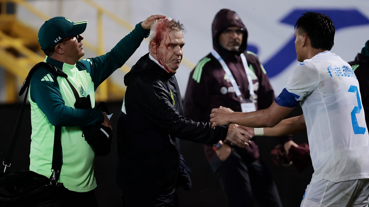 Javier Aguirre leaves the pitch with a head injury