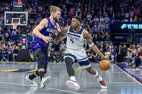 NBA: Timberwolves guard Anthony Edwards (5) drives to the basket as Kings forward Domantas Sabonis