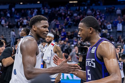 NBA: Timberwolves guard Anthony Edward, left, talks with Kings guard De'Aaron Fox
