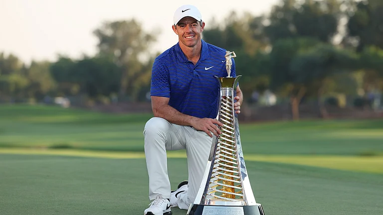 McIlroy poses with the Race to Dubai trophy - null